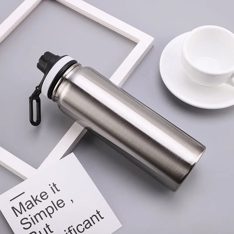 CoreTherm Steel Bottle on a gray surface, showcasing its durable design and portable functionality.