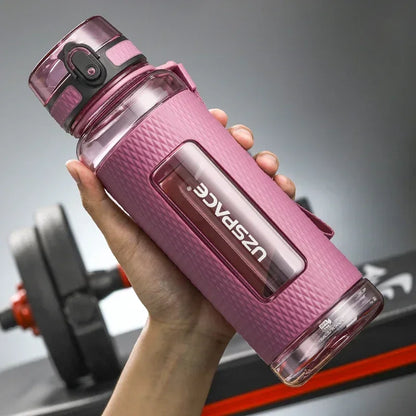 Portable BPA-Free Sports Water Bottle in hand, featuring leak-proof design and easy one-click lid, perfect for gym and travel.