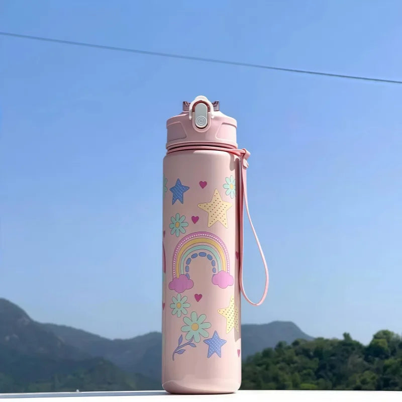 DinoSip Kids Water Bottle with rainbow and star designs against a clear blue sky.