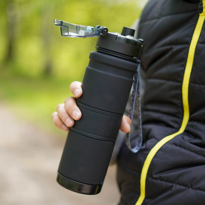 HydroLock Sport Bottle in hand, featuring a one-click lid and a lightweight, durable design for easy hydration.