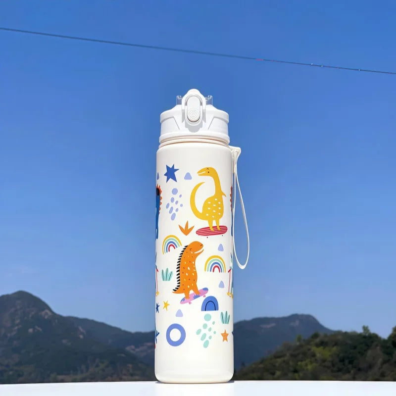 DinoSip Kids Water Bottle with colorful dinosaur and rainbow designs against a blue sky.