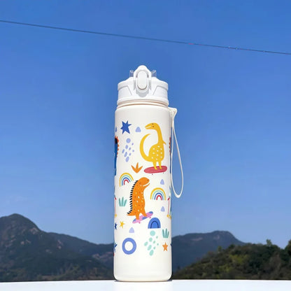 DinoSip Kids Water Bottle with colorful dinosaur and rainbow designs against a blue sky.