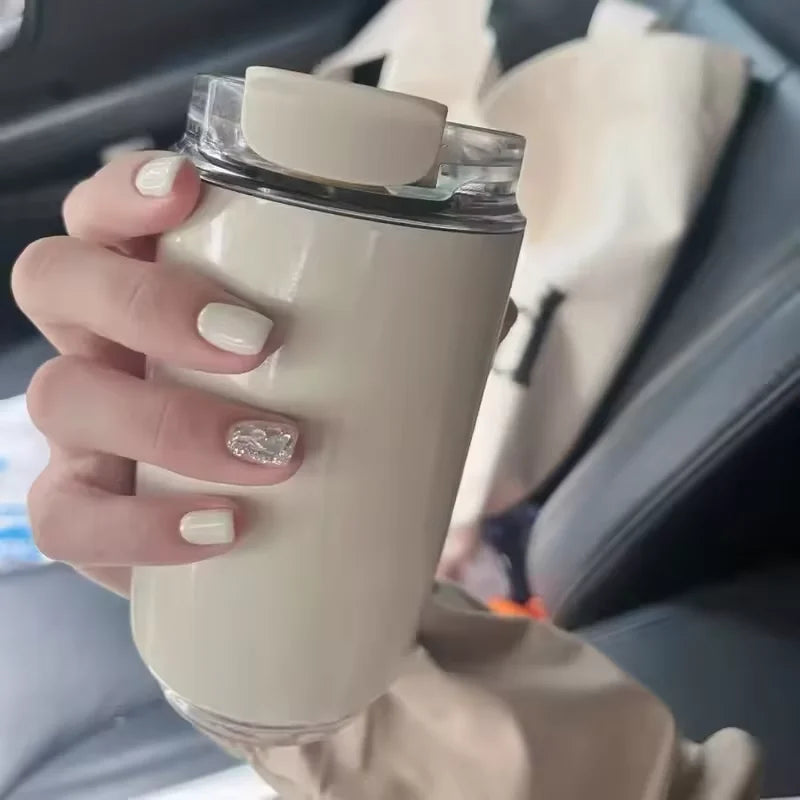 Insulated travel mug held in hand, showcasing sleek design and spill-proof lid, perfect for drinks on the go.