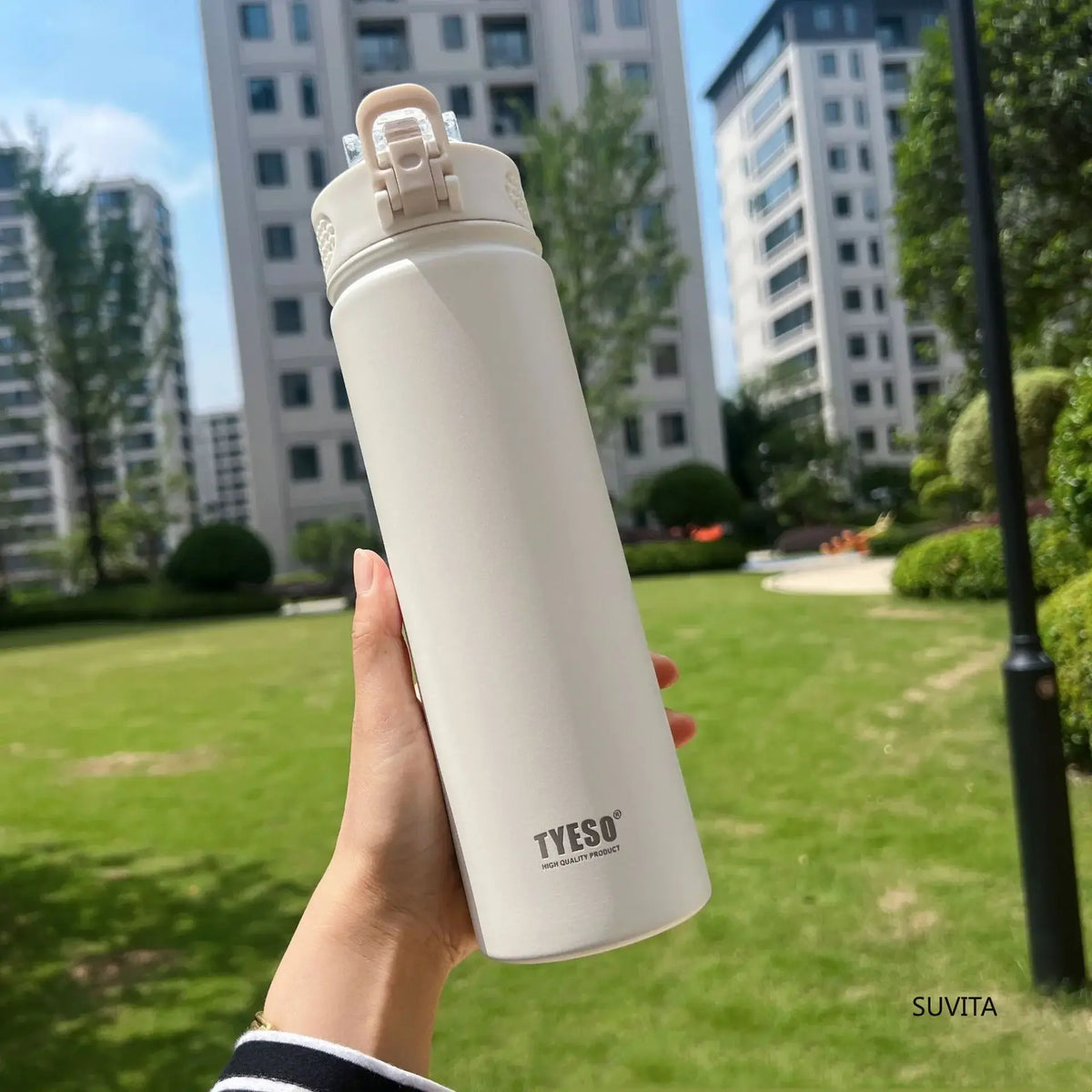 ActiveSip Bottle, a durable insulated water bottle held in hand outdoors with modern buildings in the background.