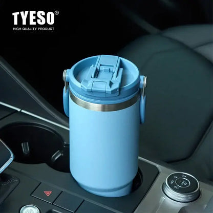 Insulated tumbler with dual-drink lid placed in a car cup holder, perfect for on-the-go hydration.