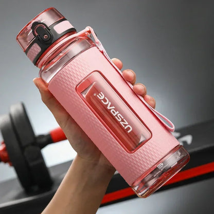 Portable BPA-Free Sports Water Bottle in hand, featuring a leak-proof design and easy one-click lid for hydration.
