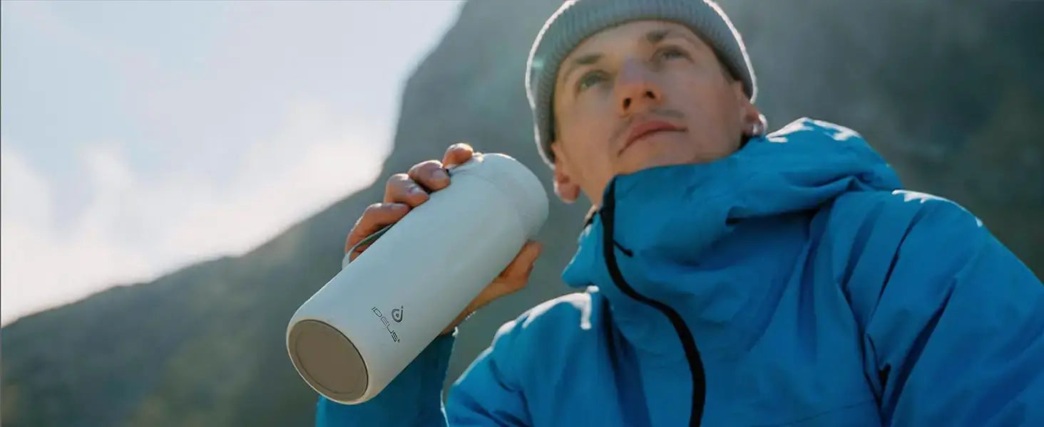Man using PureSip Thermal Bottle outdoors, enjoying hot or cold drinks in a sleek, insulated design.