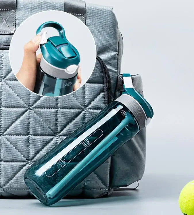 HydroFlow water bottle next to a bag, showcasing its built-in straw and leak-resistant lid design.