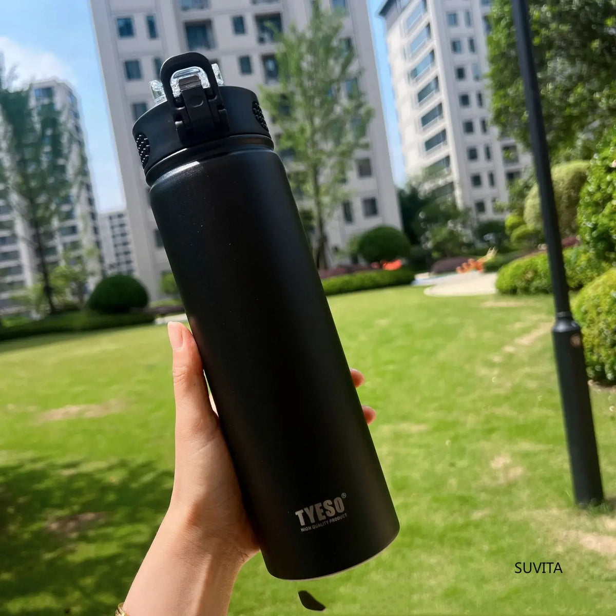ActiveSip Bottle - durable insulated water bottle held outdoors in a park setting for hydration on the go.