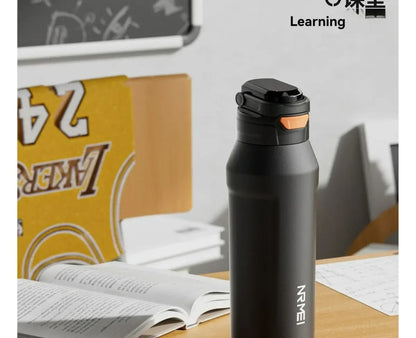 durable stainless steel water bottle on a desk, perfect for hydration during study or work.