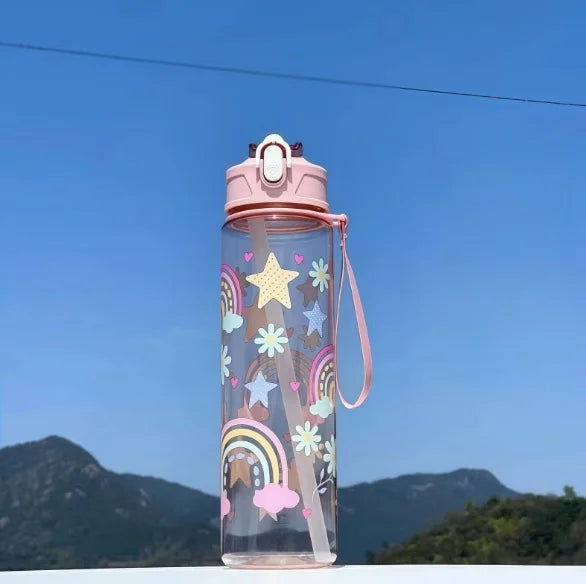 DinoSip Kids Water Bottle featuring colorful rainbow and star designs against a clear sky.
