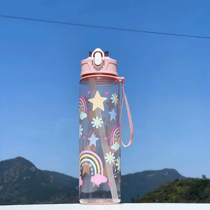 DinoSip Kids Water Bottle featuring colorful rainbow and star designs against a clear sky.