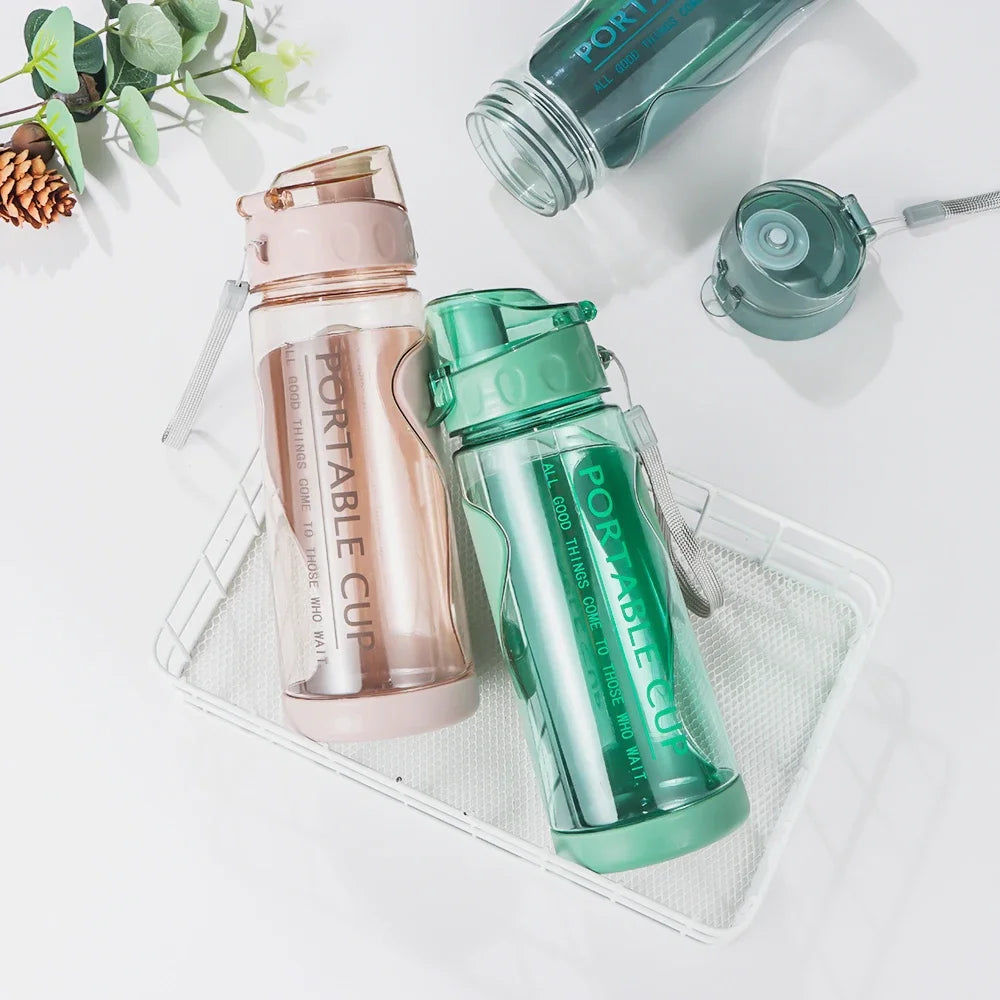 FlexSip Travel Bottle in green and pink, lightweight, leakproof with flip-top straw for hydration on the go.