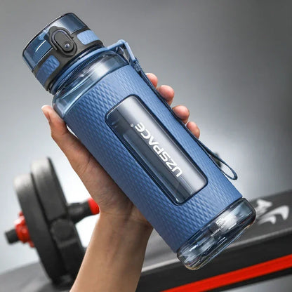 Portable BPA-Free Sports Water Bottle held in hand, featuring a leak-proof design and one-click lid, perfect for active use.