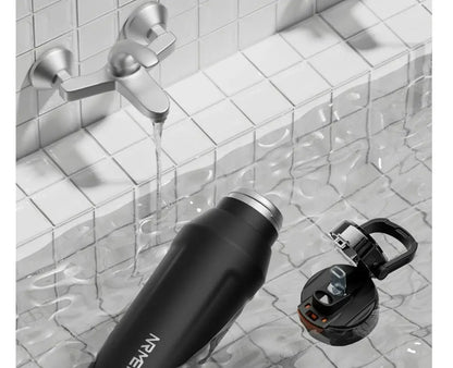 PowerFlow Bottle in a stylish setting, showcasing durable stainless steel water bottle design and convenient lid.