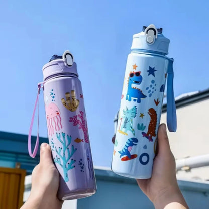 Two colorful DinoSip Kids Water Bottles featuring fun designs in hands against a blue sky.