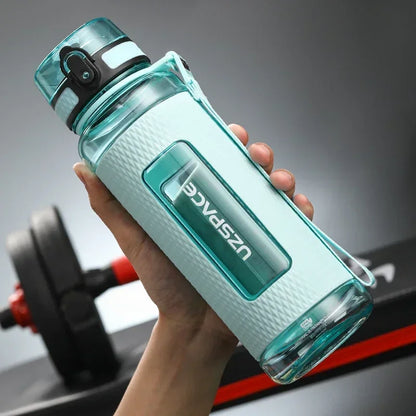 Portable BPA-Free Sports Water Bottle held in hand with a textured grip and one-click lid, ideal for fitness and hydration.