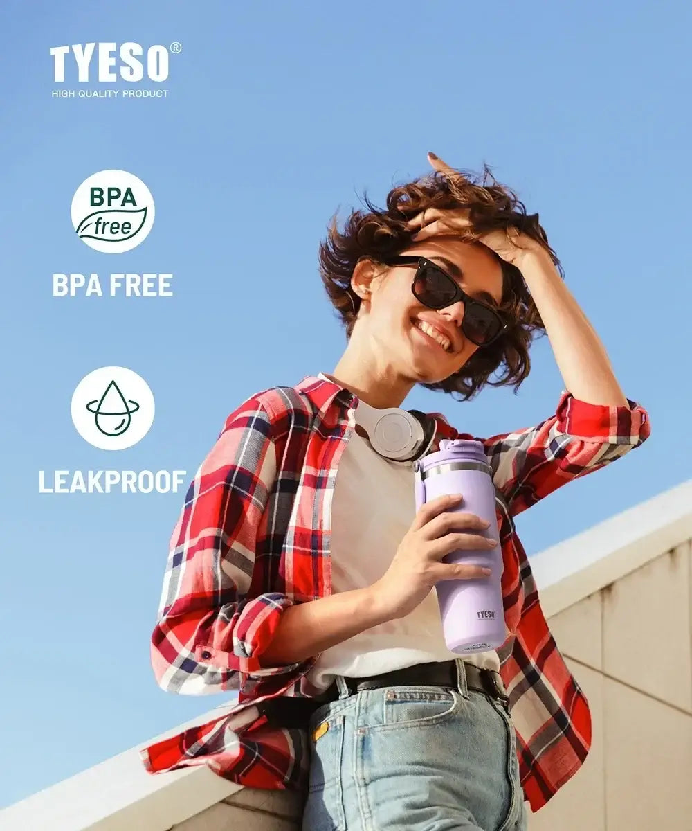 Woman enjoying an insulated tumbler with dual-drink lid, showcasing BPA free and leakproof features in sunny outdoor setting.